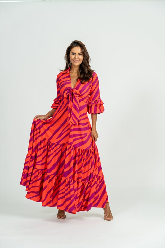 Load and play video in Gallery viewer, Video showcasing Sago Maxi Dress with V-neck bow tie, puff sleeves, and tiered maxi skirt
